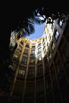 Spain, Catalonia, Barcelona, View upwards from one of the circular courtyards within the Casa Mila apartment building known as La Pedrera or Stone Quarry designed by Antoni Gaudi in the Eixample distr...