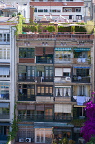 Spain, Catalonia, Barcelona, Apartment building with a planted roof garden and balconies in the Eixample District.