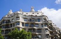 Spain, Catalonia, Barcelona, Facade of Casa Mila apartment building known as La Pedrera or Stone Quarry designed by Antoni Gaudi in the Eixample district.