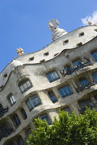 Spain, Catalonia, Barcelona, Facade of Casa Mila apartment building known as La Pedrera or Stone Quarry designed by Antoni Gaudi in the Eixample district.