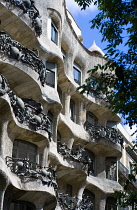 Spain, Catalonia, Barcelona, Facade of Casa Mila apartment building known as La Pedrera or Stone Quarry designed by Antoni Gaudi in the Eixample district.