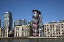 England, London, Isle of Dogs,Thames riverside blocks with Canary Wharf in background.
