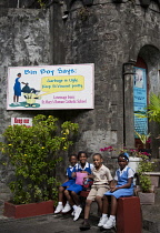 Saint Vincent and the Grenadines, Saint Vincent, Kingston, Children outside school with anti littering sign.