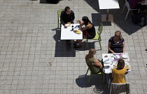 Spain, Catalonia, Barcelona, PEople sat having lunch outside in the square of the World Trade Centre.