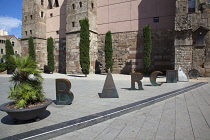 Spain, Catalonia, Barcelona,  scuplture by Joan Brossa in front of Barcelonas Roman wall, where the aqueduct once entered the city and spells out the word Barcino, the Roman name of Barcelona