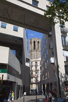 Spain, Catalonia, Barcelona, View along Passatge D'Amadeu Bagues from La Rambla through modern architecture to old bell tower.