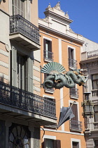 Spain, Catalonia, Barcelona, Dragon sculpture on Building in Placa de la Boqueria on  La Rambla.