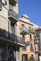 Spain, Catalonia, Barcelona, Dragon sculpture on Building in Placa de la Boqueria on the tree lined avenue of La Rambla.