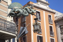 Spain, Catalonia, Barcelona, Dragon sculpture on Building in Placa de la Boqueria on La Rambla.