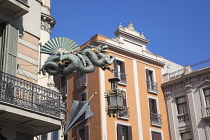Spain, Catalonia, Barcelona, Dragon sculpture on Building in Placa de la Boqueria on  La Rambla.