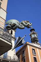 Spain, Catalonia, Barcelona, Dragon sculpture on Building in Placa de la Boqueria on  La Rambla.