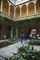 Spain, Catalonia, Barcelona, Tourists in the courtyard of the Crown of Aragon archive building.