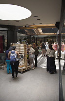Spain, Catalonia, Barcelona, Craft stalls in small shopping arcade.