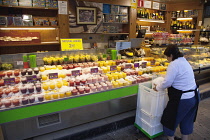 Spain, Catalonia, Barcelona, Fresh fruit juice vendor covering drinks in crushed ice.