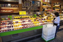 Spain, Catalonia, Barcelona, Fresh fruit juice vendor covering drinks in crushed ice.