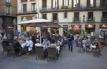 Spain, Catalonia, Barcelona, Cafe with tourists sat outside in La Ribera.