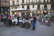 Spain, Catalonia, Barcelona, Cafe with tourists sat outside in La Ribera.