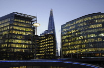 England, London, Offices in More London with The Shard at dusk.