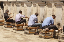 Turkey, Istanbul, Men washing their feet in preparation for prayers, at Suleymaniye Mosque.
