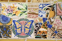 Spain, Catalunya, Barcelona, Parc Guell by Antoni Gaudi, one of the tiled mosaic benches on Banc de Trencadis.