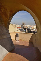 Spain, Catalunya, Barcelona, distant view of La Sagrada Familia from the rooftop of La Pedrera .