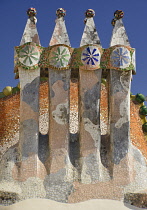 Spain, Catalunya, Barcelona, Antoni Gaudi's Casa Batllo building, colourful chimney pots on the roof terrace.