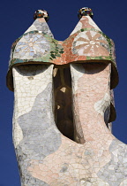 Spain, Catalunya, Barcelona, Antoni Gaudi's Casa Batllo building, colourful chimney pots on the roof terrace.