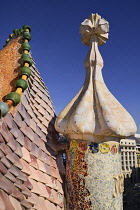 Spain, Catalunya, Barcelona, Antoni Gaudi's Casa Batllo building, dragon's back feature on the roof terrace with the four armed cross also inclluded.