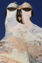 Spain, Catalunya, Barcelona, Antoni Gaudi's Casa Batllo building, colourful chimney pots on the roof terrace.