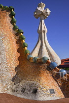 Spain, Catalunya, Barcelona, Antoni Gaudi's Casa Batllo building, dragon's back feature on the roof terrace with the four armed cross also inclluded.