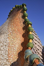 Spain, Catalunya, Barcelona, Antoni Gaudi's Casa Batllo building, detail of dragon's back feature on the roof terrace.