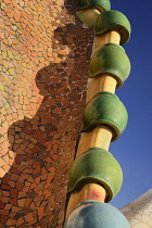 Spain, Catalunya, Barcelona, Antoni Gaudi's Casa Batllo building, detail of dragon's back feature on the roof terrace.