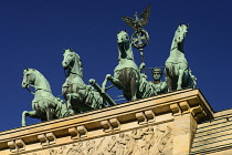 Germany, Berlin, The Brandenburg Gate, The Quadriga on top of the gate featuring a chariot drawn by four horses driven by Victoria the Roman goddess of victory or possibly Eirene goddess of peace.