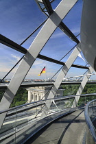 Germany, Berlin, Reichstag Parliament Building, Interior view of the Glass Dome designed by Norman Foster with German flag visible outside.