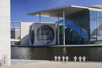 Germany, Berlin, Marie Elisabeth Luders Haus which is a service centre of the Bundestag located across the River Spree behind the Reichstag with memorial crosses to Berlin Wall victims in the foregrou...