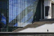 Germany, Berlin, Pedestrian walking along the River Spree in front of Marie Elizabeth Luders Haus.