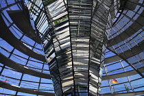 Germany, Berlin, Reichstag Parliament Building, Interior view of the Glass Dome designed by Norman Foster with German flag visible outside.