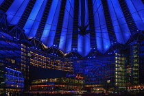 Germany, Berlin, Potzdamer Platz, Sony Centre with glass canopied roof over central plaza at night.