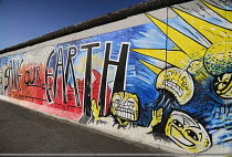 Germany, Berlin, The East Side Gallery, a 1.3  km long section of the Berlin Wall, Mural known as  'Save our Earth' by Artist Indiano.