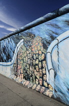 Germany, Berlin, The East Side Gallery, a 1.3  km long section of the Berlin Wall, Mural known as  ‘It happened in November’ by Kani Alavi.