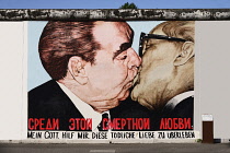 Germany, Berlin, The East Side Gallery, a 1.3  km long section of the Berlin Wall, Mural called 'My God help me survive this deadly love' Soviet Premier Brezhnev kisses East German Chancellor Honecker...