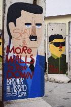 Germany, Berlin, Checkpoint Charlie, Open air exhibition showing Berlin Wall section making a political statement regarding Basher Al-Assad and alleged use of sarin.