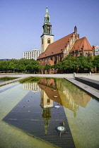 Germany, Berlin, Marienkirche, St Marys Church dating from the 13th Century, reflected in fountain pool.