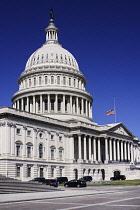 USA, Washington DC, Capitol Building, Angular view of the central section with the dome and American flag at half mast.