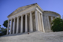USA, Washington DC, National Mall, Thomas Jefferson Memorial, a lone tourist sitting on the steps beneath the facade.