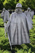 USA, Washington DC, National Mall, Korean War Veterans Memorial, Statues of soldiers on patrol in combat gear among juniper bushes.