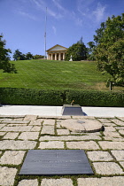 USA, Washington DC, Arlington National Cemetery, Grave of President JF Kennedy with Arlington House in background.