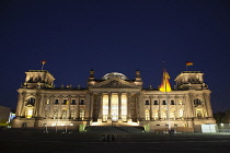 Germany, Berlin, Mitte, Reichstag building with glass dome deisgned by Norman Foster, illuminated at night.