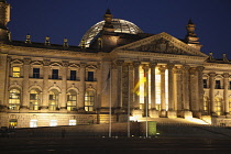 Germany, Berlin, Mitte, Reichstag building with glass dome deisgned by Norman Foster, illuminated at night.