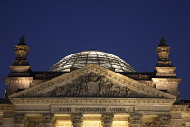 Germany, Berlin, Mitte, Reichstag building with glass dome deisgned by Norman Foster, illuminated at night.